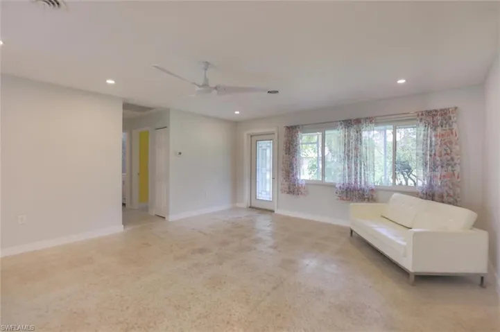 Unfurnished living room featuring ceiling fan