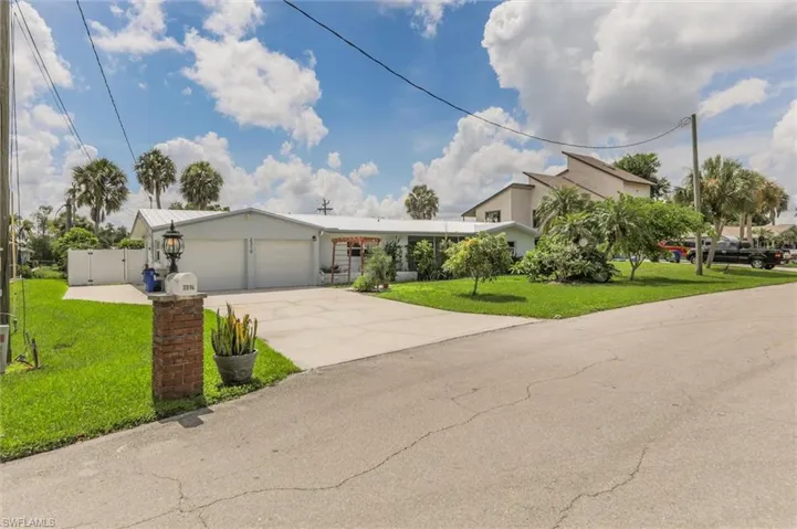 View of front of home featuring a garage and a front lawn