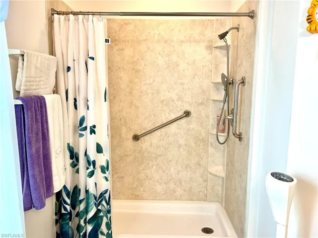 Bathroom featuring a shower with shower curtain
