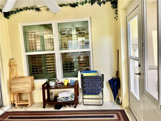 Sunroom with acrylic windows, AC, tile floors and TV hung.