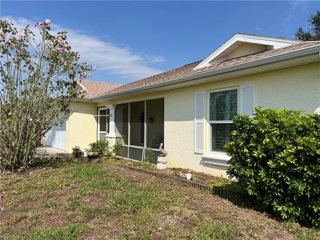 Front of house featuring a garage and a screened entry & sitting srea.