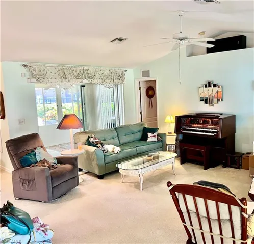 Great room with lofted ceiling and ceiling fan