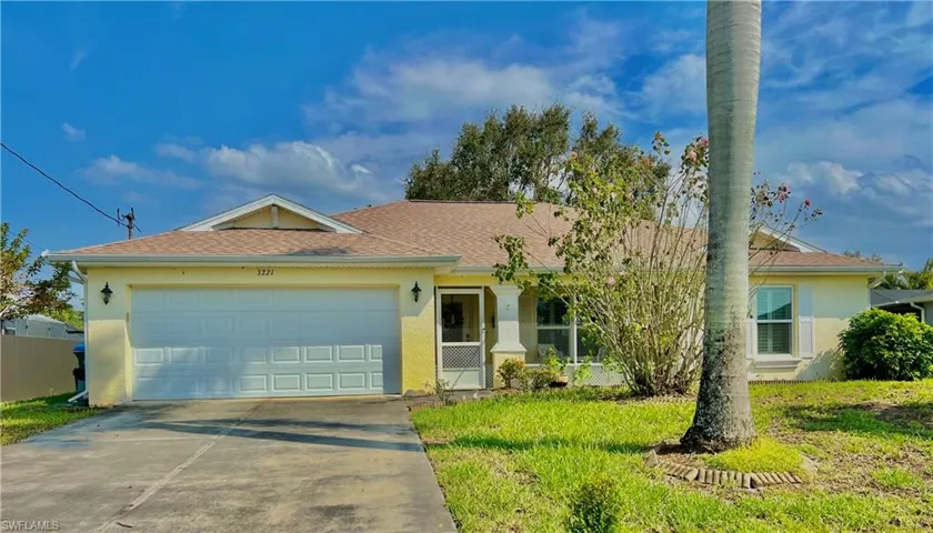 Single story home featuring a garage and a front lawn
