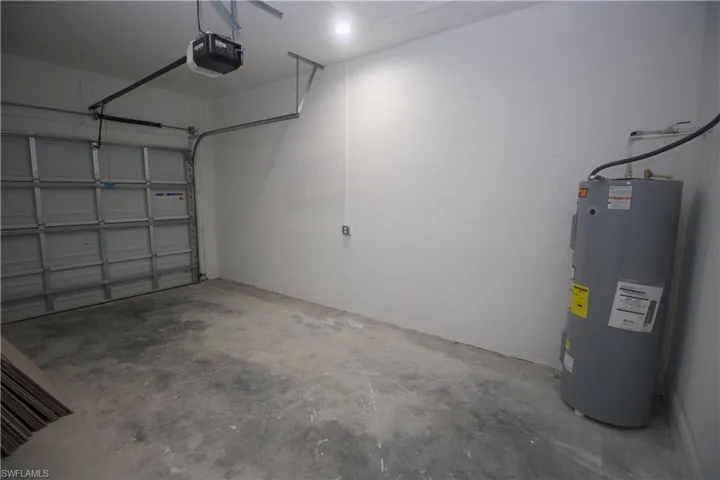 Garage with water heater and a garage door opener