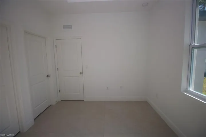 Bedroom featuring light tile patterned flooring