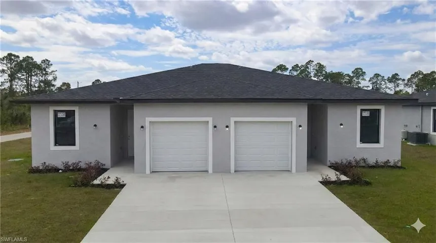 Ranch-style house with an attached garage, a front lawn, driveway, a shingled roof, and stucco siding