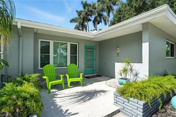 Property entrance featuring stucco siding and a patio area