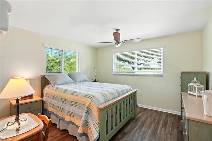 Bedroom with wood-style floors and a ceiling fan