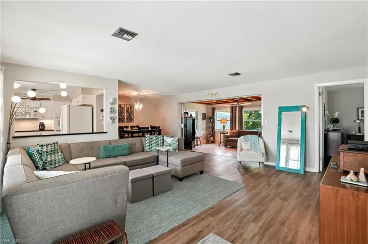 Living room with wood finished floors and a chandelier