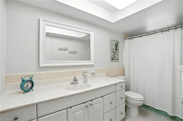 Bathroom with vanity, tile walls, tile patterned flooring