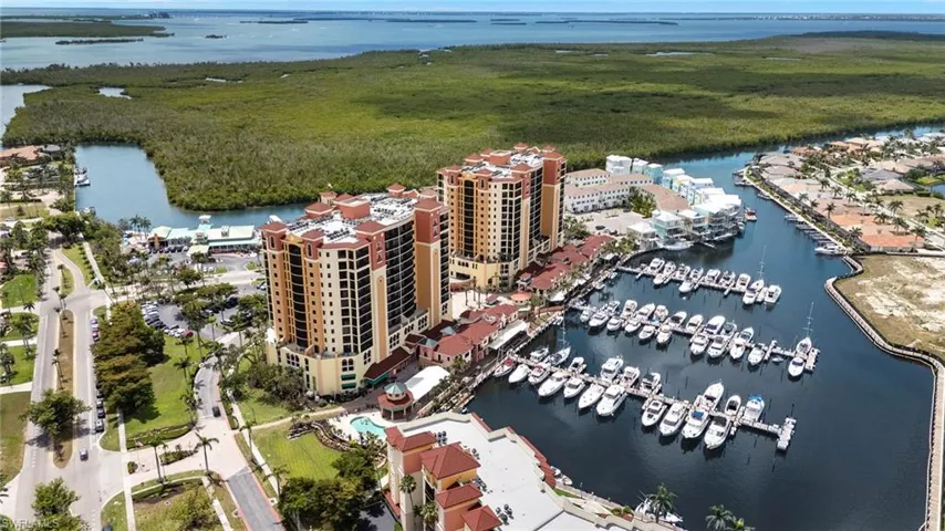 Birds eye view of property with a water view