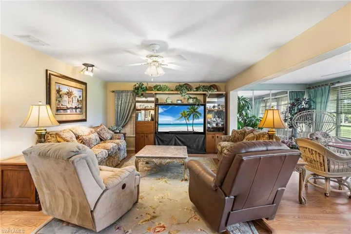 Living room featuring wood finished floors and a ceiling fan