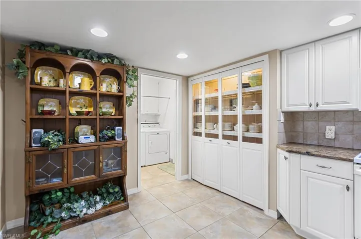 Lighted pantry, doorway to laundry room and garage