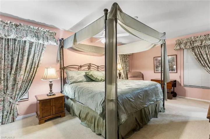 Carpeted bedroom with baseboards and a ceiling fan