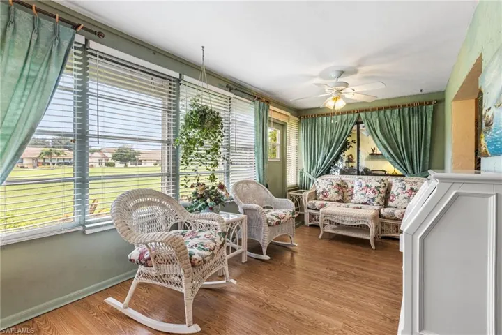Sunroom with wood finished floors and baseboards
