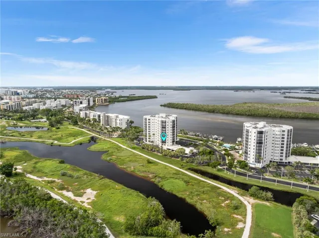 View of urban area with apartment complex / building and a nearby body of water