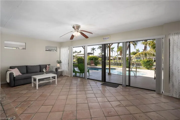 Living room featuring ceiling fan and light tile patterned floors