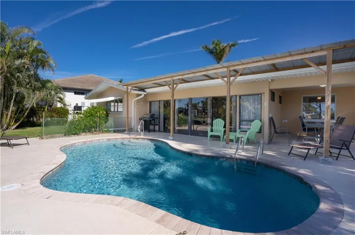 View of swimming pool featuring a patio area and area for grilling