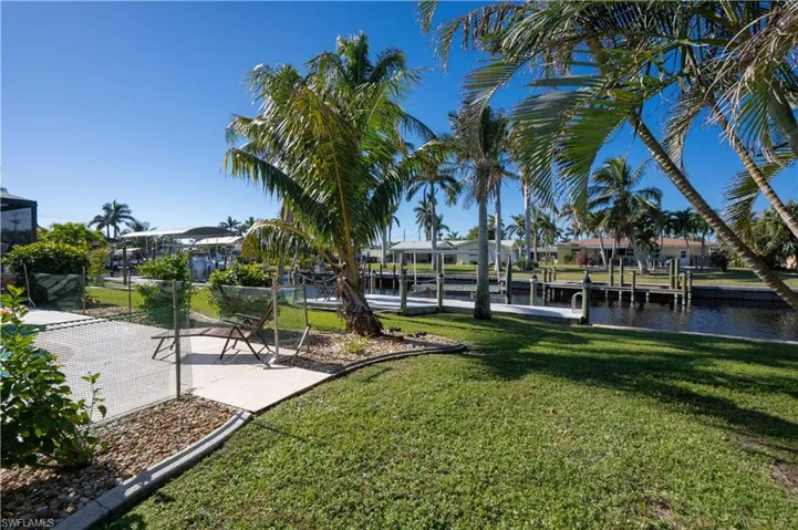View of dock featuring a water view and a yard