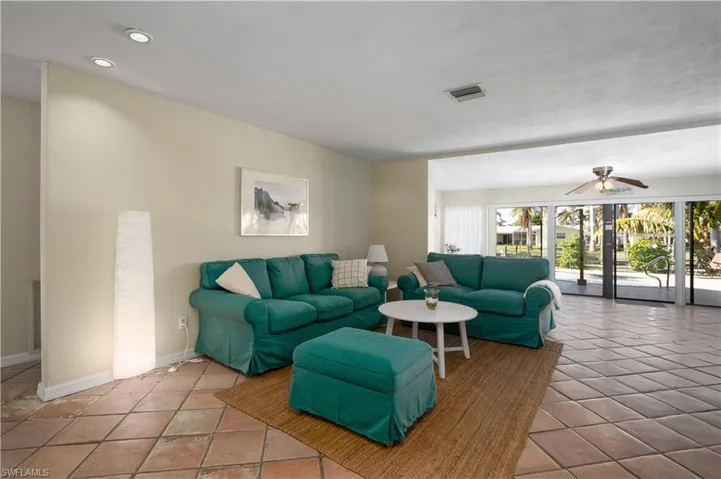 Tiled living room featuring ceiling fan
