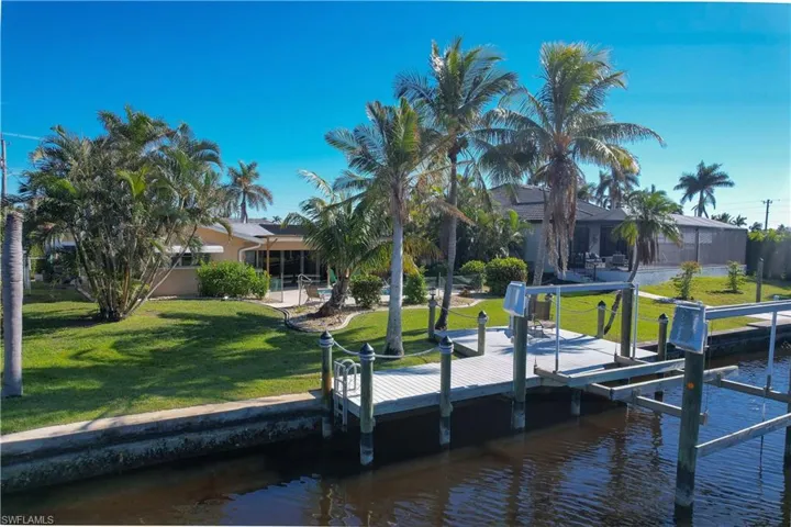 Dock area with a yard and a water view