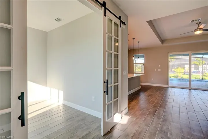 Unfurnished room featuring a barn door.