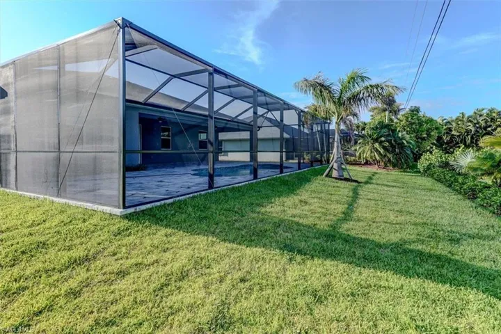 View of yard with glass enclosure