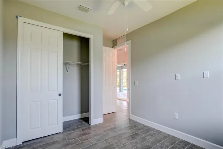 Unfurnished bedroom with a closet and ceiling fan