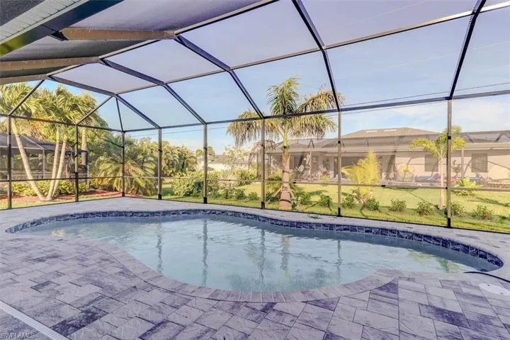 View of swimming pool with a lanai