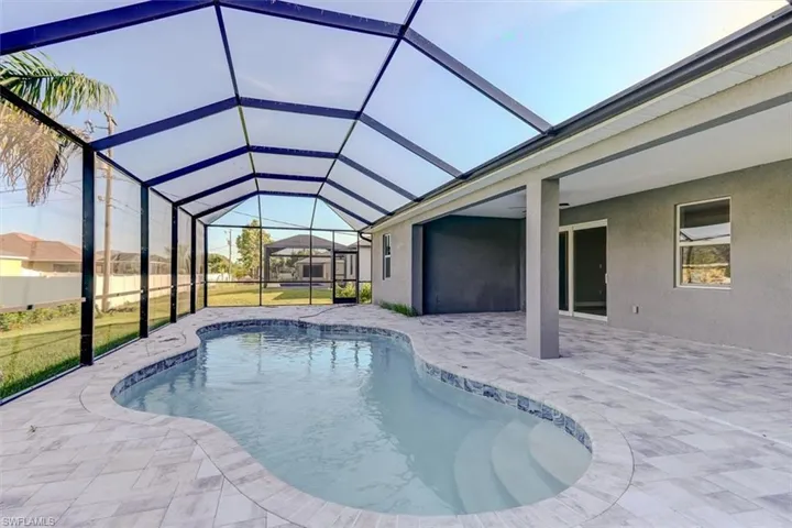 View of swimming pool featuring a patio and a lanai