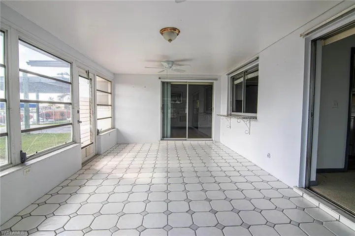 Unfurnished sunroom with a ceiling fan