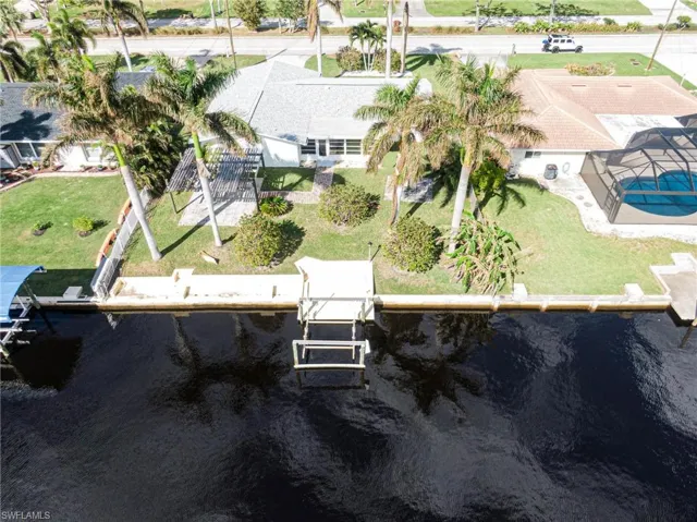Aerial view of property and surrounding area featuring a nearby body of water