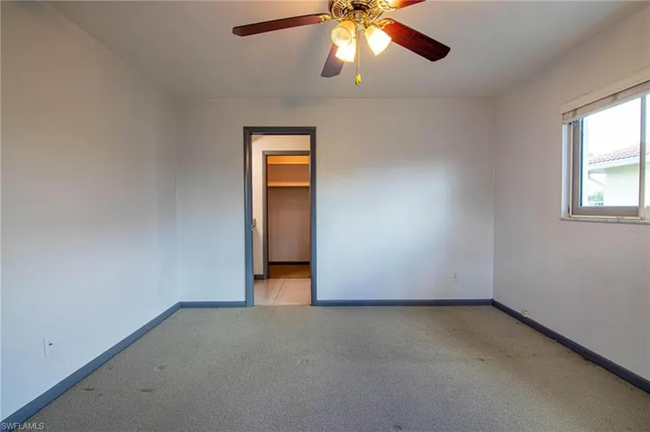 Empty room featuring light carpet and ceiling fan