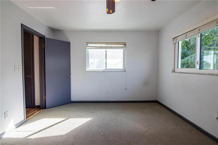 Unfurnished bedroom with carpet floors and ceiling fan