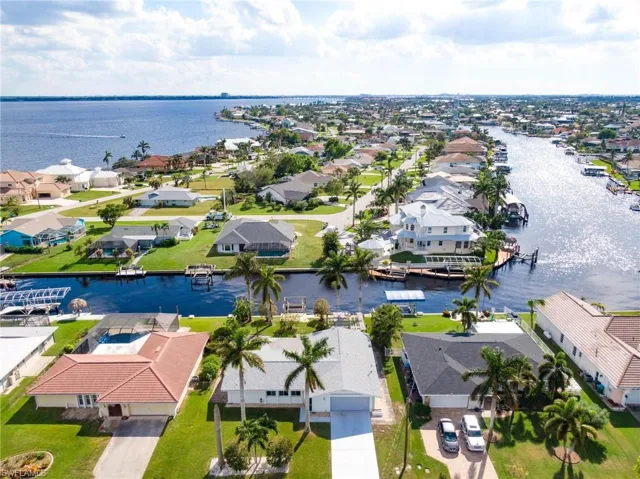 Aerial view of residential area featuring a large body of water