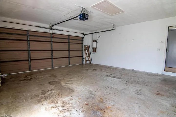 Garage featuring a garage door opener and a central vacuum unit