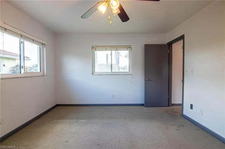 Unfurnished bedroom featuring carpet floors and a ceiling fan