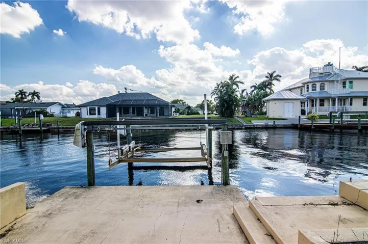 Dock with a residential view, a water view, and boat lift