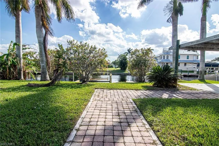 View of green lawn featuring a water view