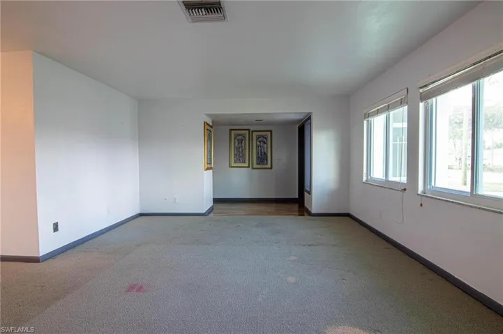 Carpeted empty room featuring baseboards