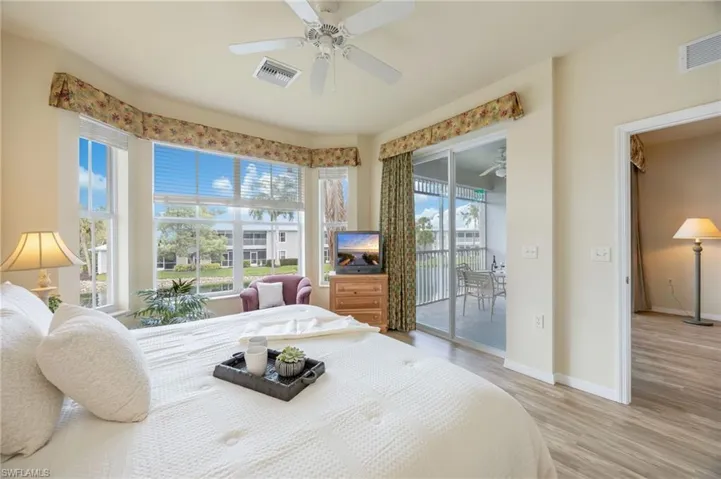 Retreat to the bright and inviting primary suite, where expansive windows fill the space with natural light. Featuring two walk-in closets and direct lanai access