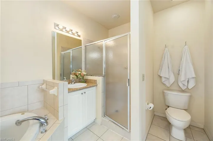 Primary bath with soaking tub, walk-in shower complete with  dual vanities.