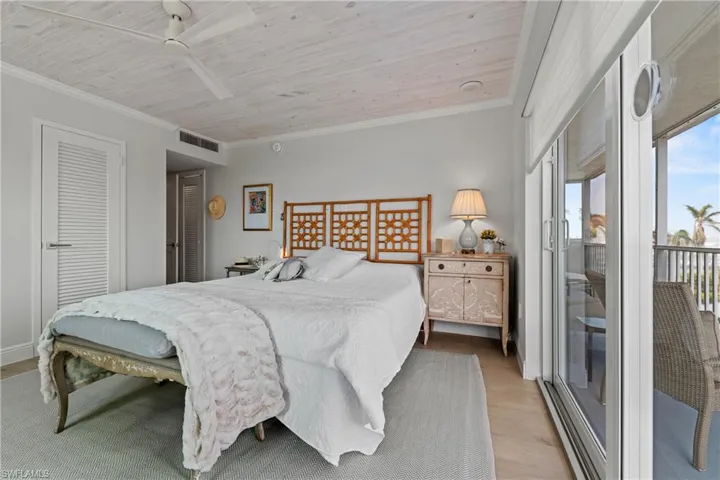 Bedroom featuring ceiling fan, crown molding, access to outside, wood ceiling, and light wood-type flooring