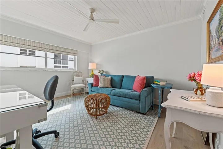 Office area featuring hardwood / wood-style flooring, ceiling fan, wooden ceiling, and ornamental molding