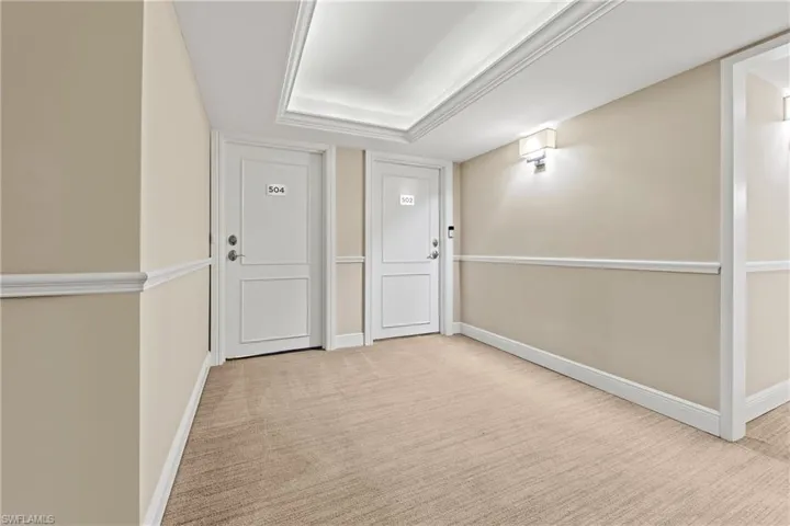 Corridor with light colored carpet
