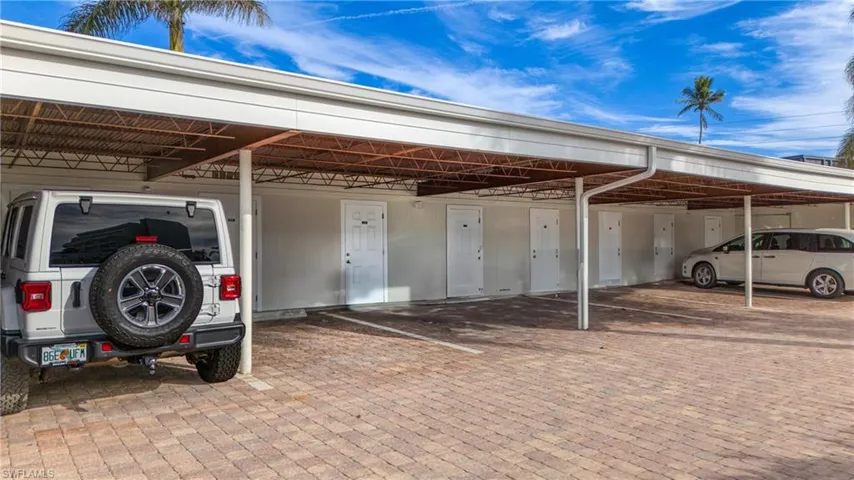 View of vehicle parking featuring a carport
