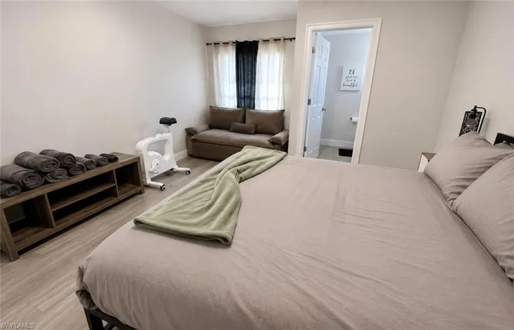 Light gray walls complement the wood-finish flooring