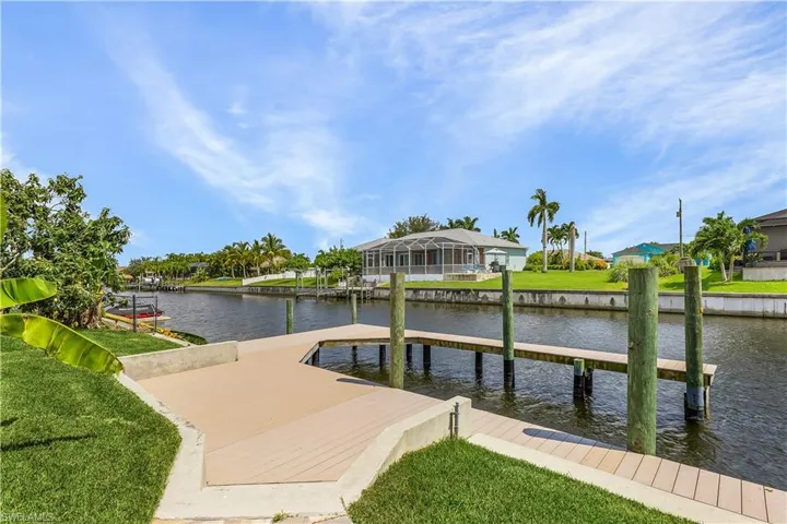 Dock area featuring a lawn and a water view