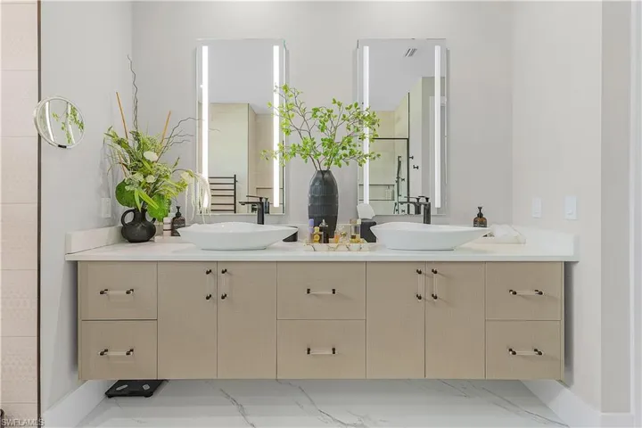 Bathroom with dual vanity and tile patterned flooring