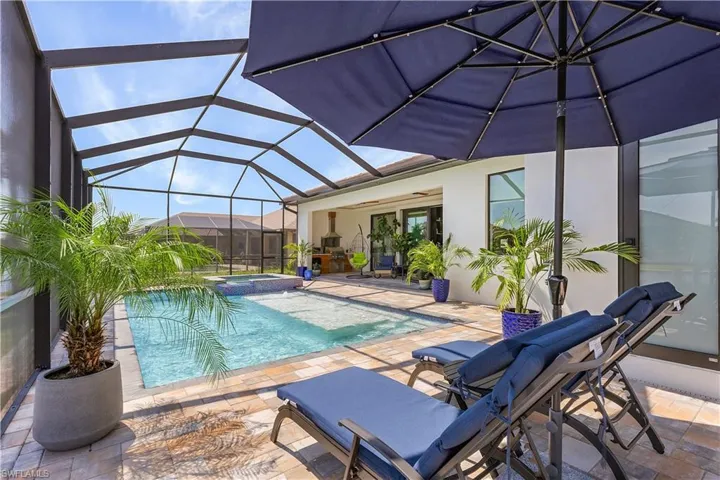 View of pool with a patio and a lanai